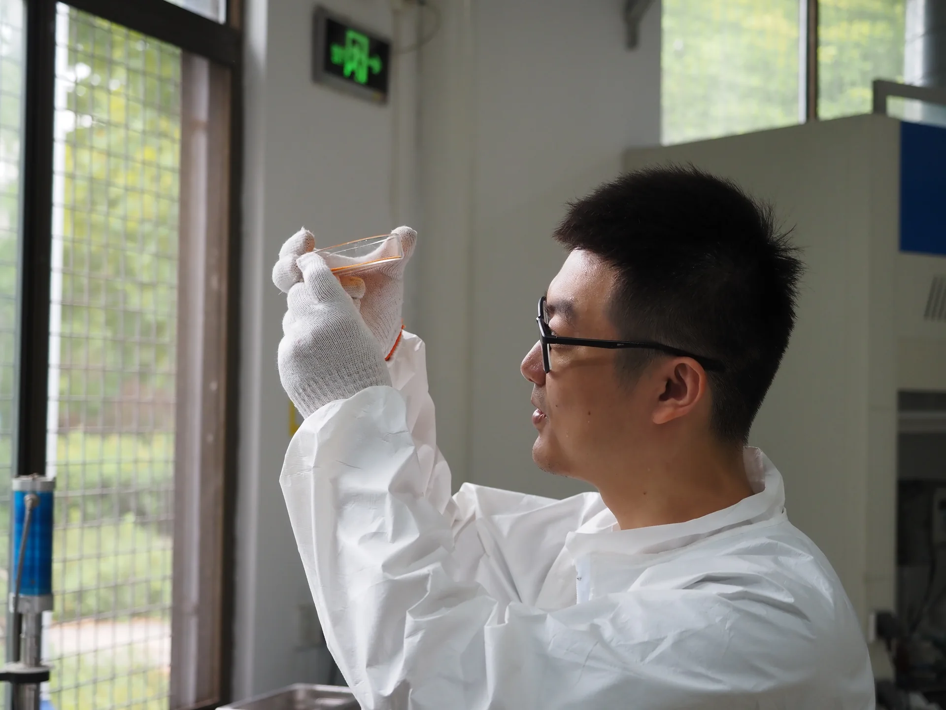 DSAN researcher holding a sample up for inspection